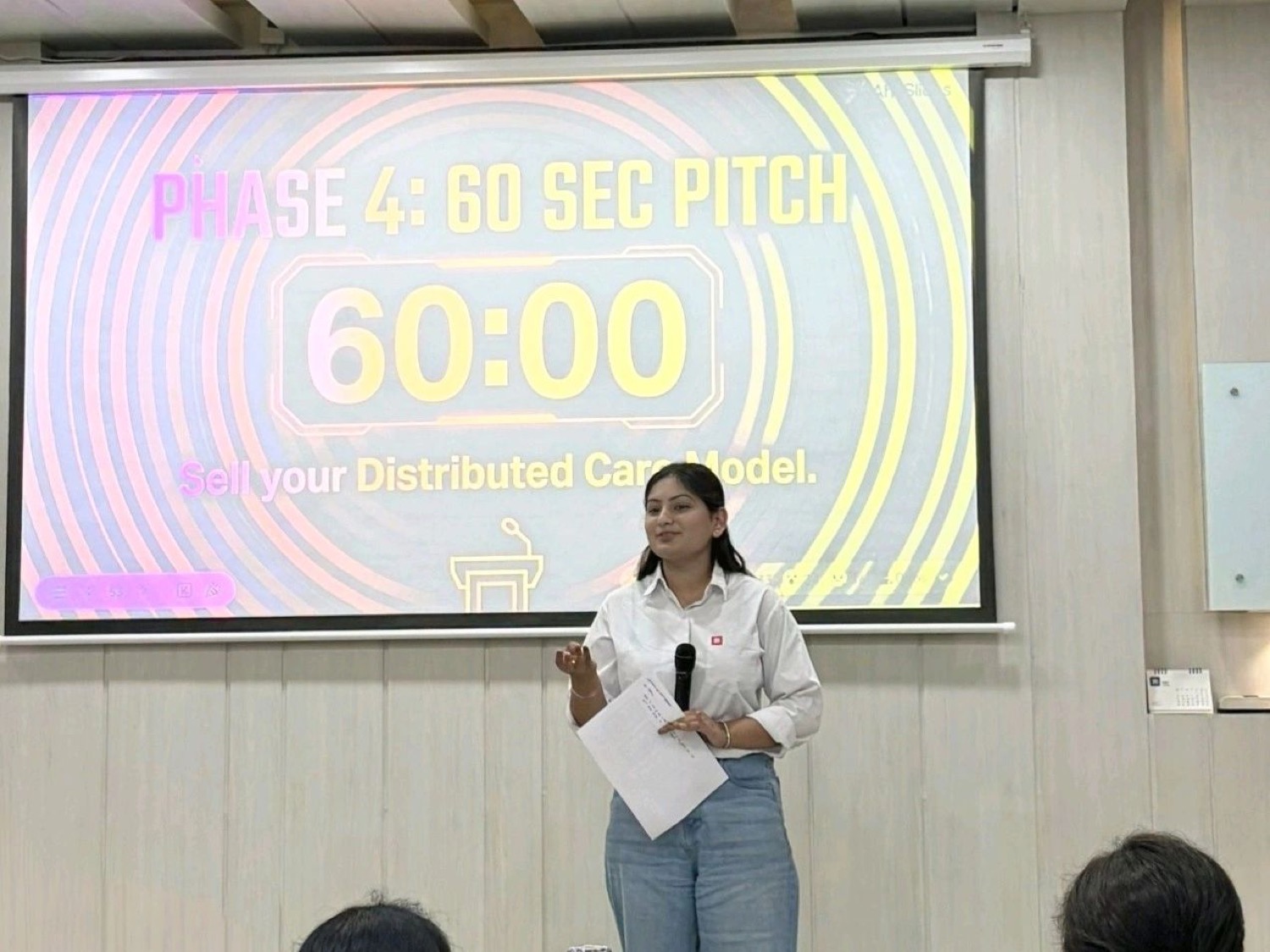 A student presenting a data analytics pitch deck on stage