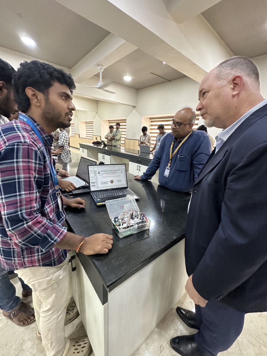 A student demonstrating the AI product they built to an industry expert