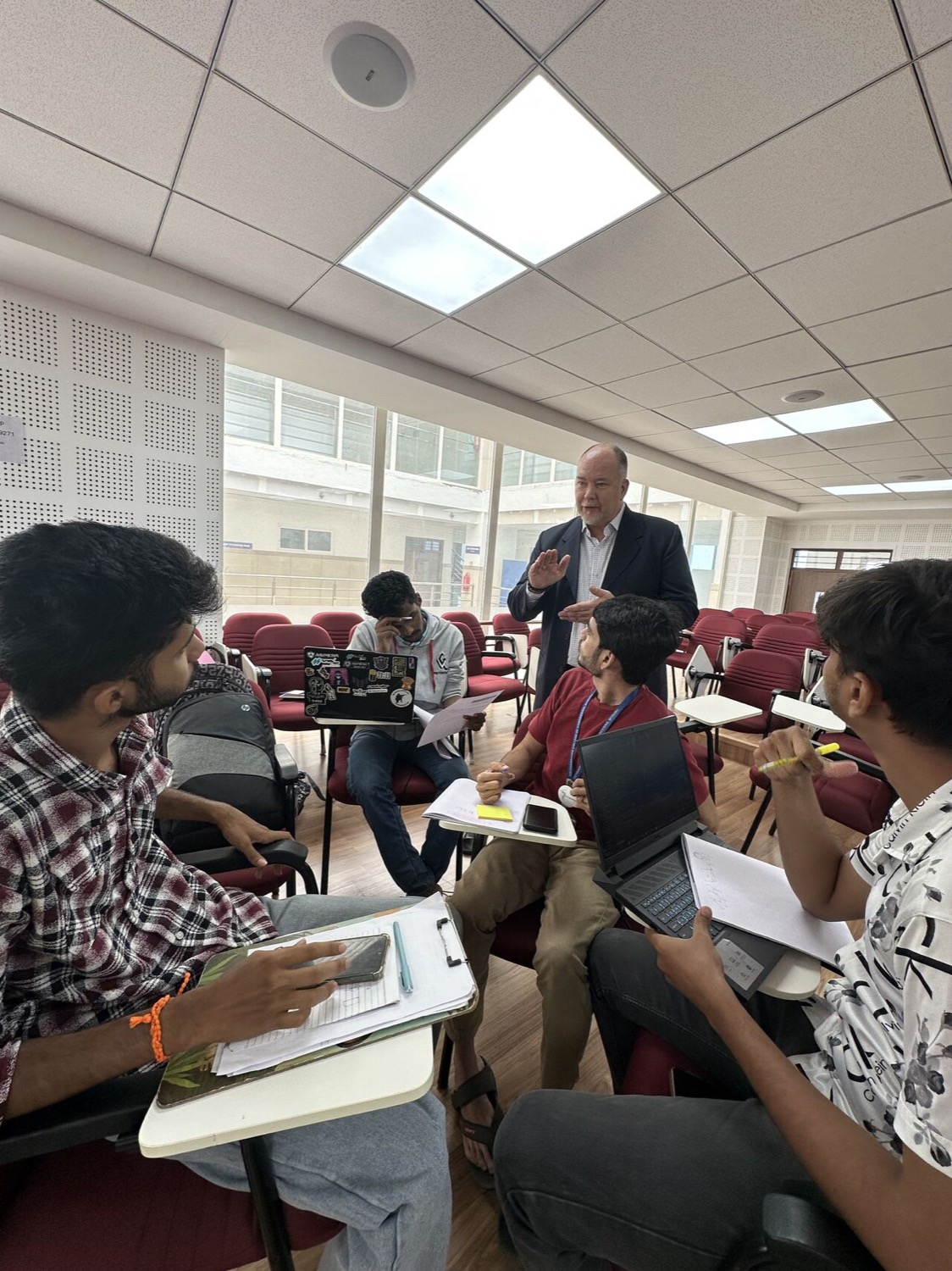 A student team building and deploying their e-commerce store on laptops